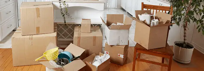 Packed moving boxes and household items in a kitchen before move-out or move-in cleaning, Knoxville, TN.